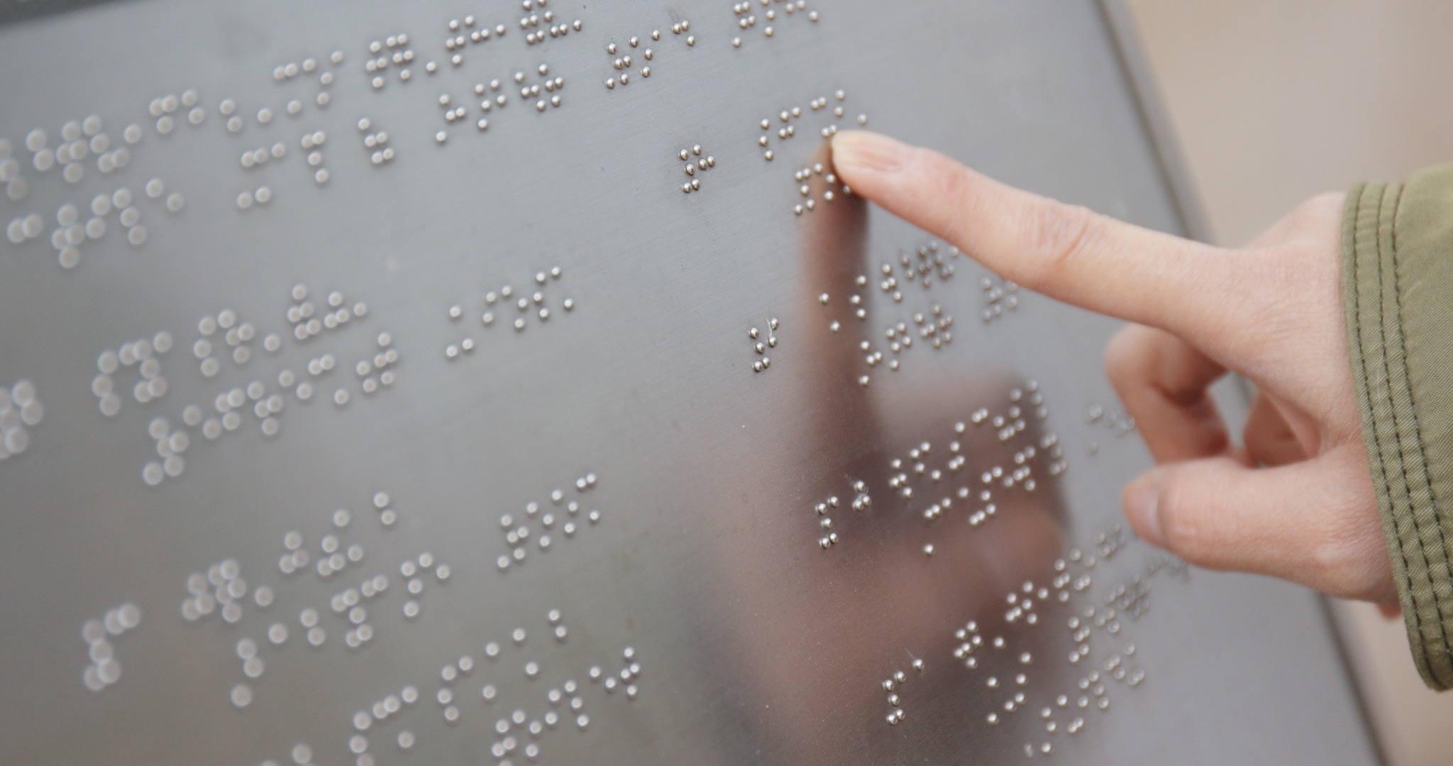 Blind reading on Braille at outdoor directory